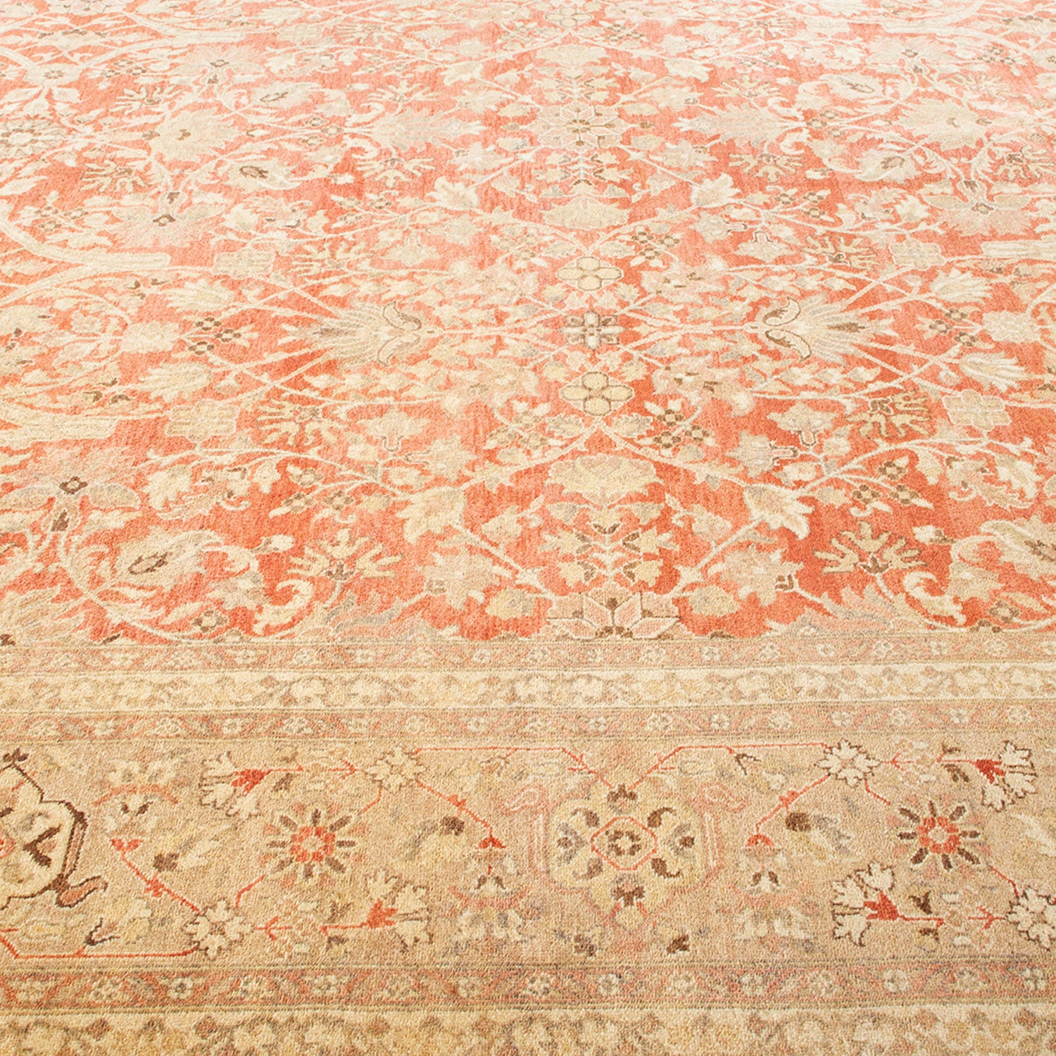 Exquisite hand-woven rug with intricate floral pattern in warm tones.