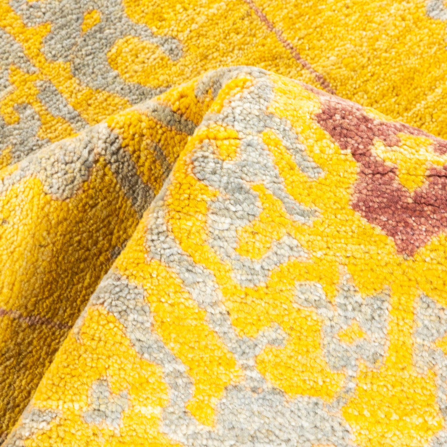 Close-up shot of a folded yellow and grey patterned rug.
