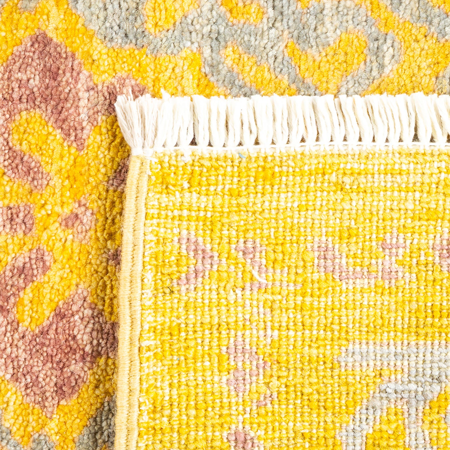 Close-up of a vibrant yellow rug with textured patterns