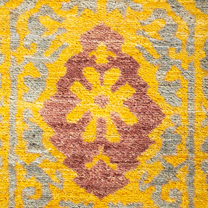 Close-up of a vibrant, intricately woven textile in rich colors.