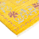 Vibrant yellow rug with purple and grey floral motifs and plush texture.