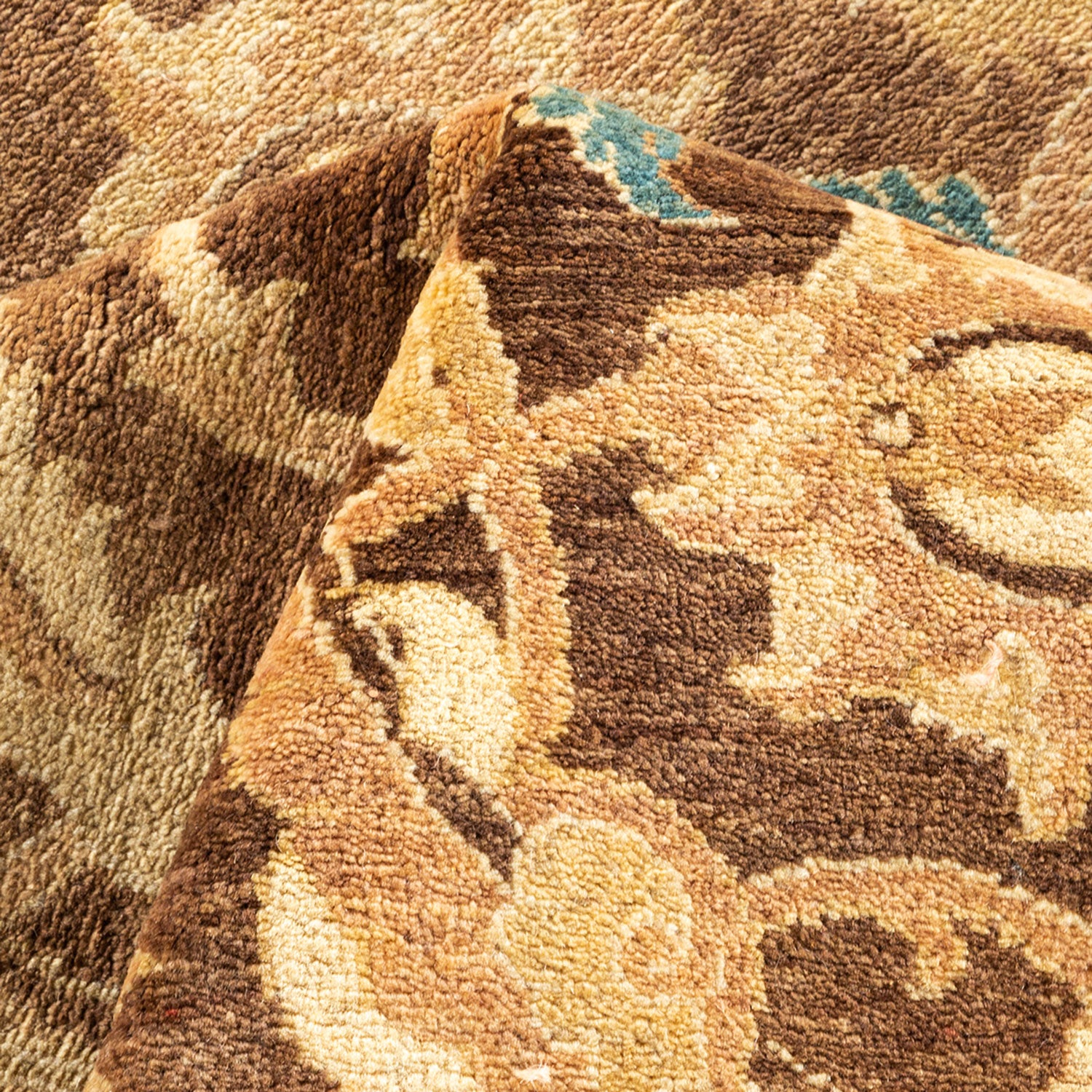 Close-up view of a plush, textured carpet with intricate floral pattern.