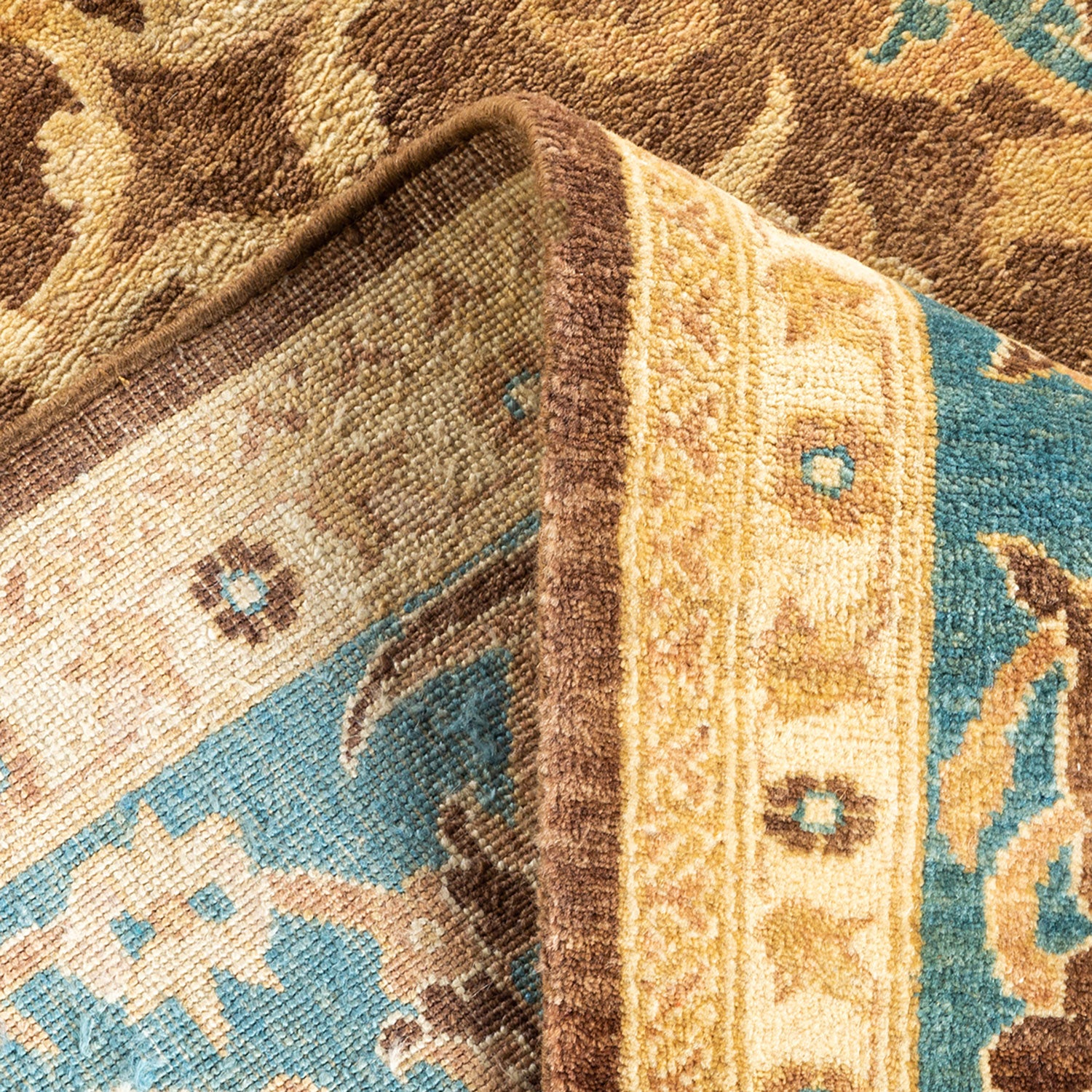 Close-up of a patterned rug displaying earthy tones and texture.