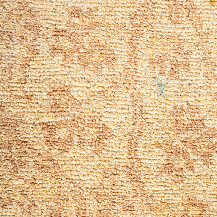 Close-up of tufted carpet showcasing intricate beige and brown pattern.
