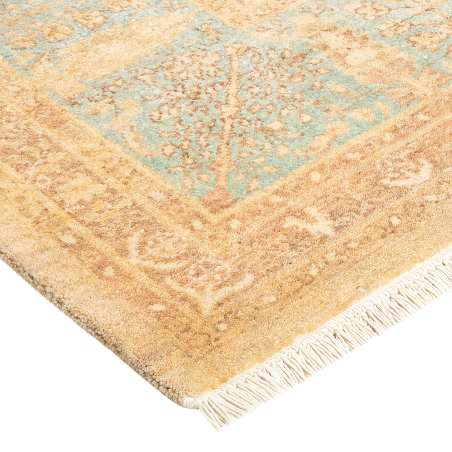 Faded vintage rug with geometric and floral motifs in turquoise and beige.