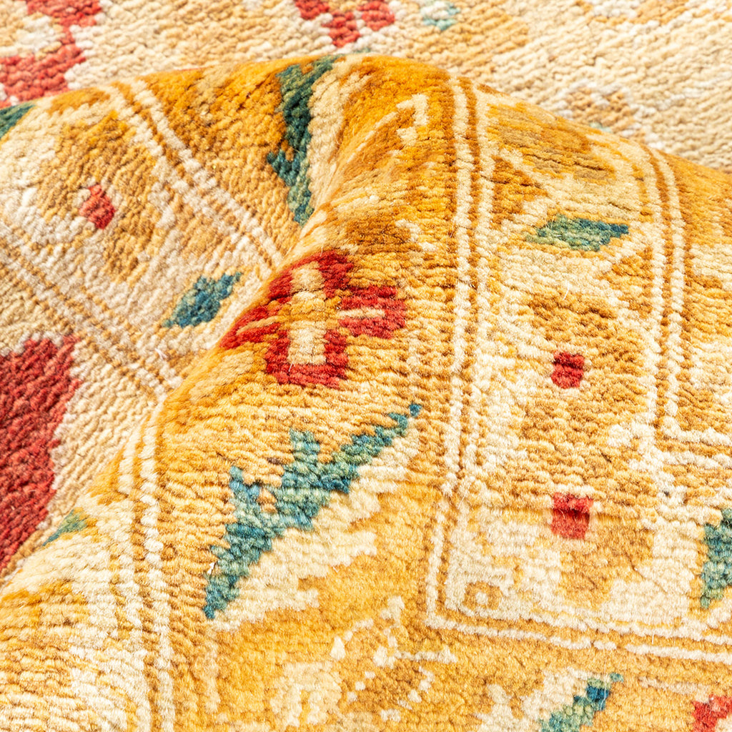 Close-up of a vibrant, textured carpet with intricate geometric design