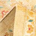Close-up of a textured rug with vibrant multicolored thread pattern.