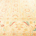 Intricate pastel-colored carpet with symmetrical oriental motifs and floral patterns.