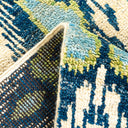 Close-up view of a patterned rug with geometric shapes and plush texture.