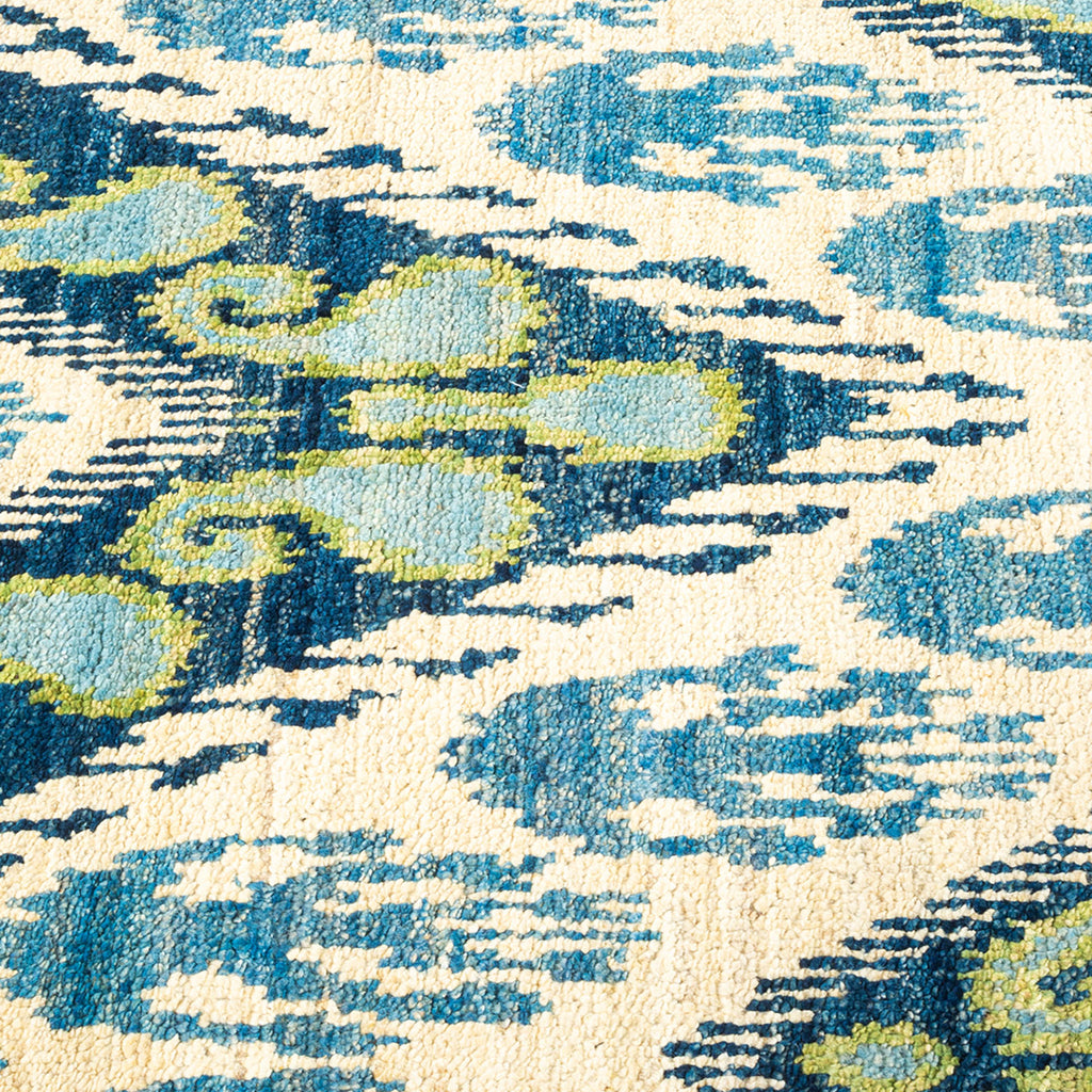 Close-up of a vibrant, watercolor-like carpet with abstract patterns