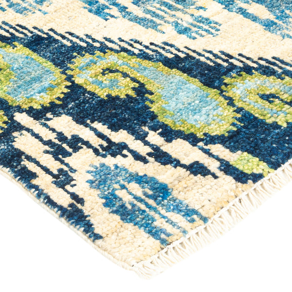 Vibrant blue and green modern rug with plush texture and fringe.