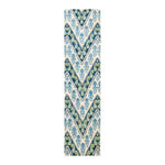 Intricate blue, cream, and taupe textile with ornate, symmetrical pattern.