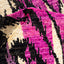 Close-up of vibrant, abstract textile with textured surface and interlocking shapes.