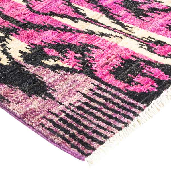 Close-up of a vibrant, textured rug with abstract patterns.