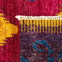 Close-up of a handcrafted woven rug with intricate, vibrant patterns.