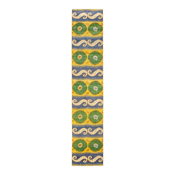 Vibrant textile with stylized motifs in blue, green, and yellow.