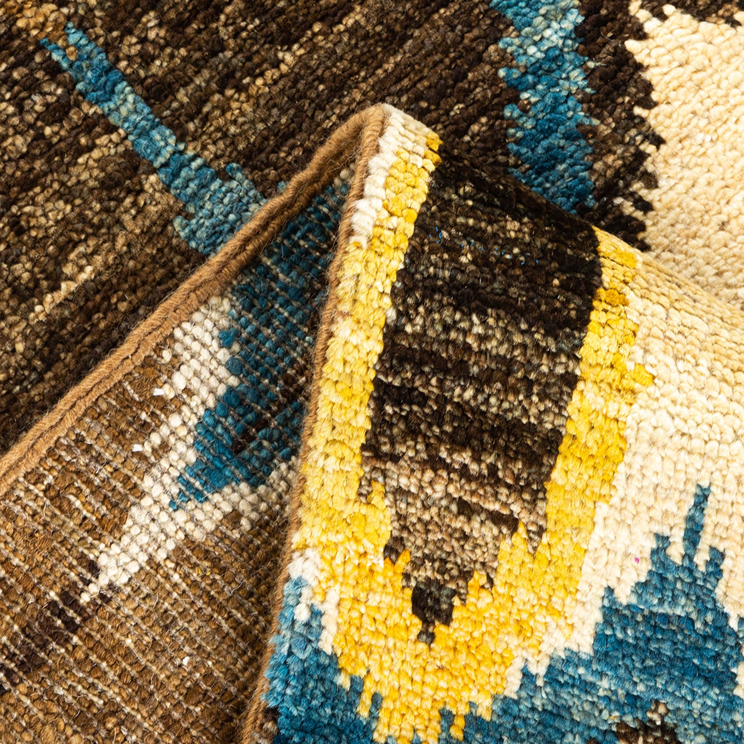 Close-up view of intricately woven textile with varied colors and texture.