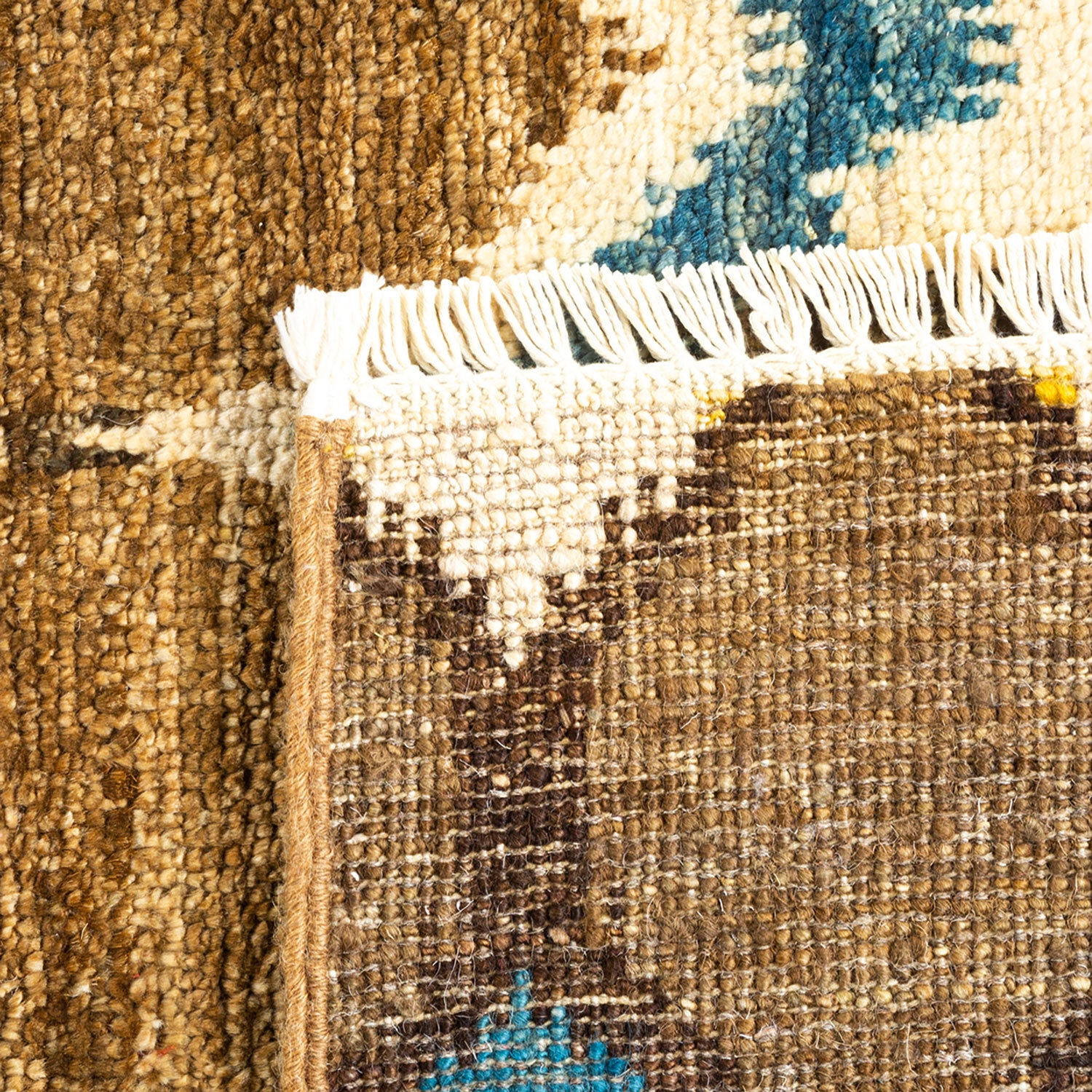 Close-up of intricately woven rug with earthy tones and patterns.