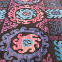 Vibrant pixelated carpet design featuring intricate circular floral motifs