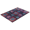 Vibrant, multicolored rug with ornate motifs in traditional yet eclectic style.