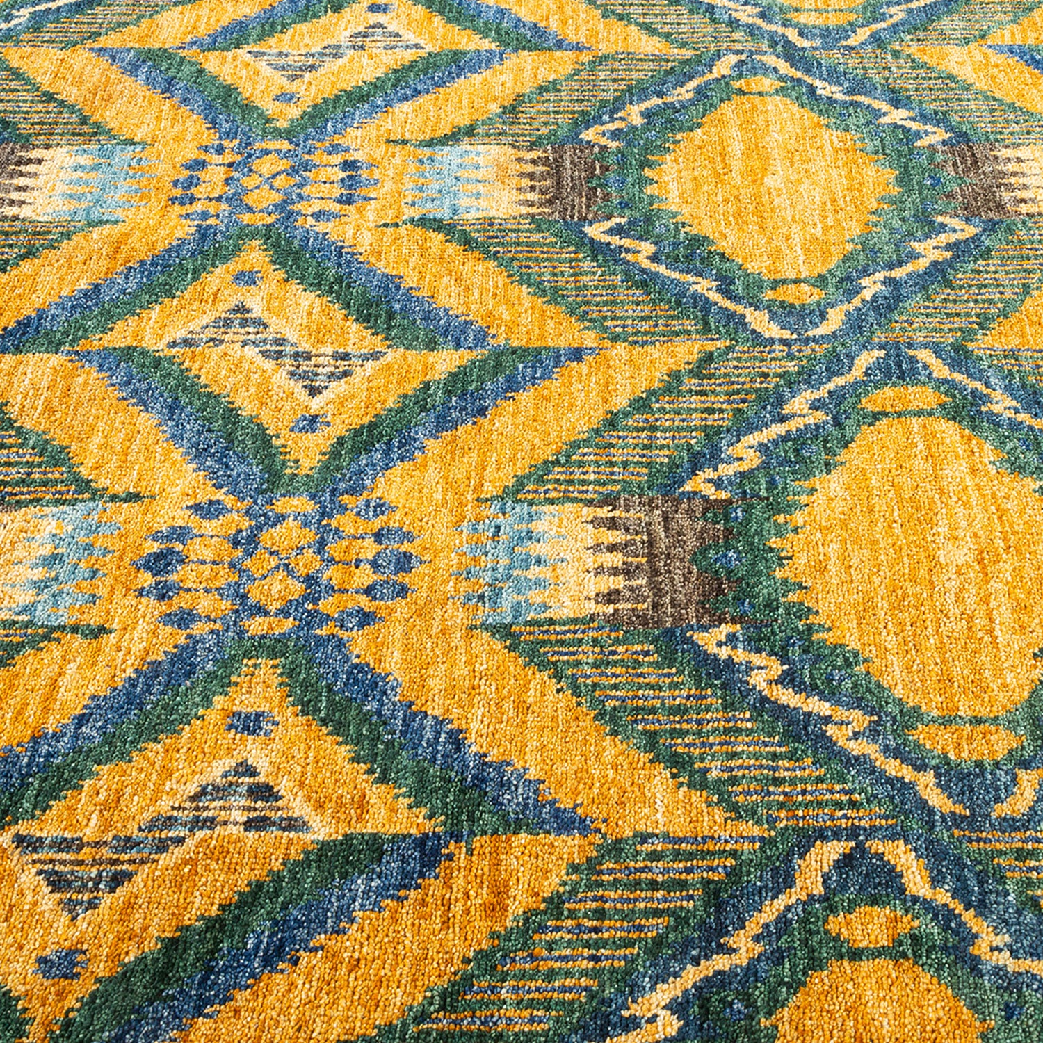 Vibrant carpet with geometric pattern in yellow, orange, green, and blue.