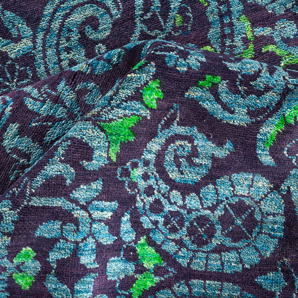 Textile with paisley and floral pattern in vibrant shades of blue and green, with a luxurious velvet-like texture.