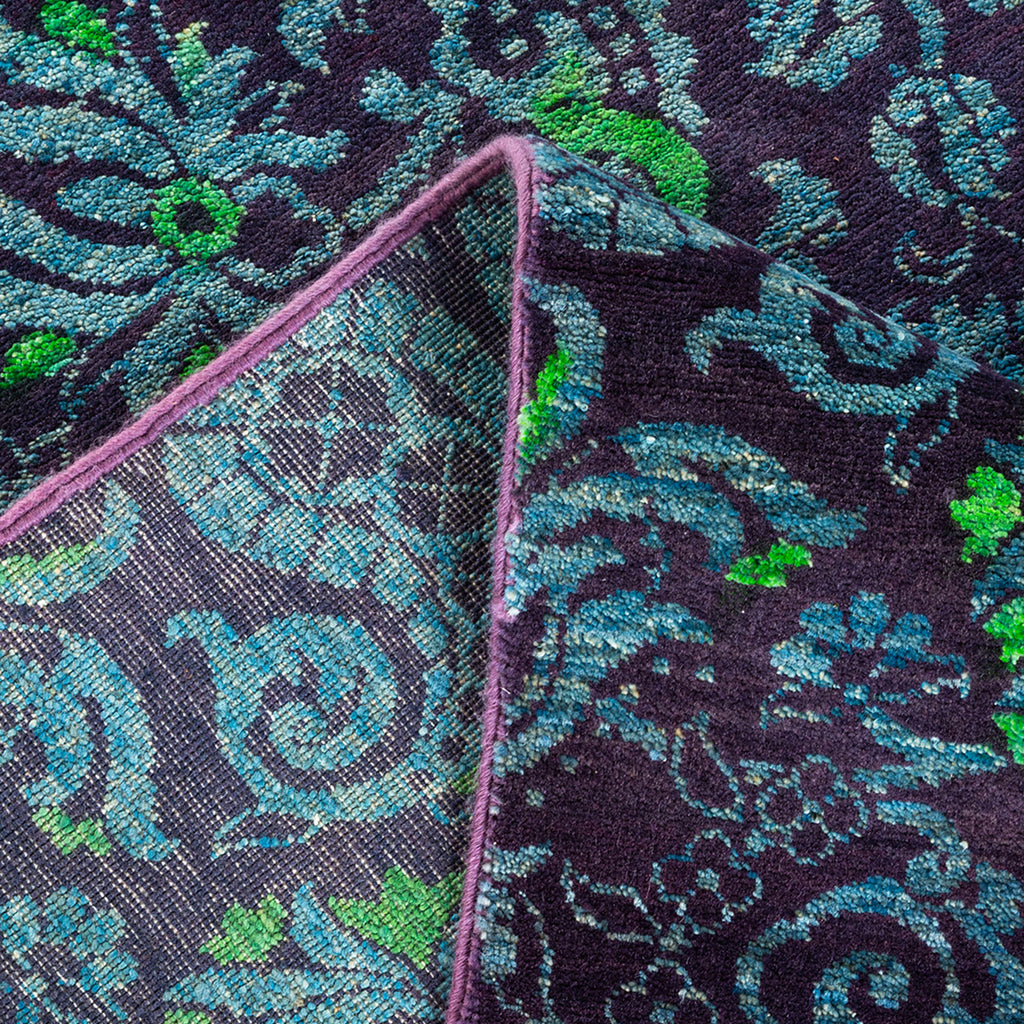 Close-up of a dark fabric with intricate floral pattern and textured surface.