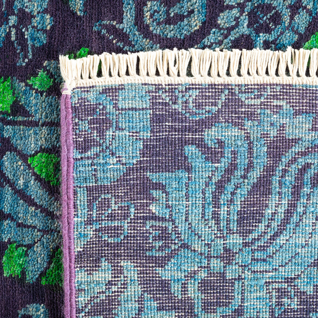 Intricate blue and purple woven textile with floral motif detail.