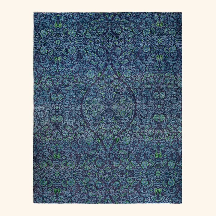 Intricate, symmetrical blue pattern resembling fabric designs with green accents.