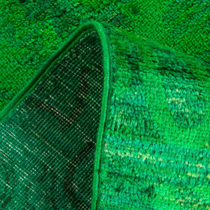 Vibrant green terrycloth fabric with plush texture, revealing fine weave.