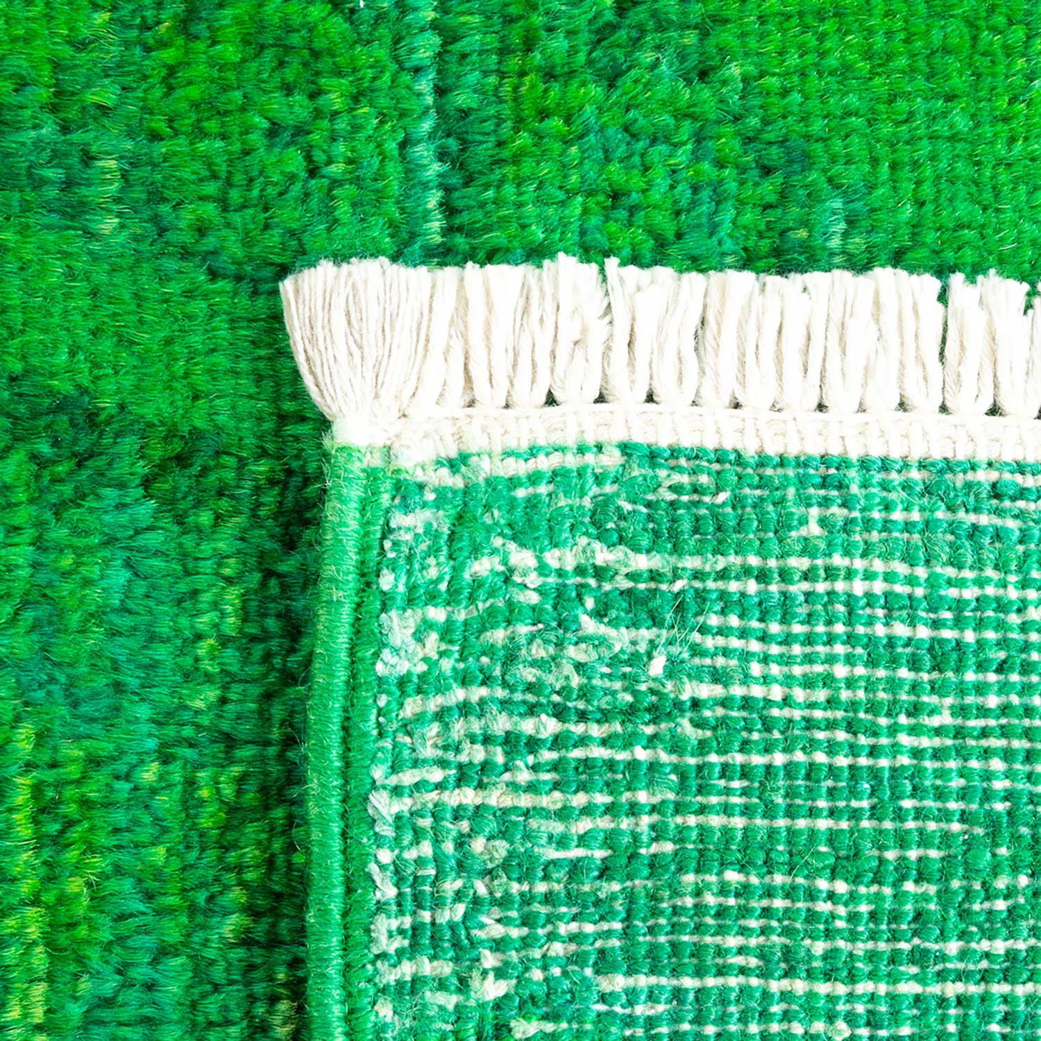 Close-up view of a green textile with plush and woven textures.