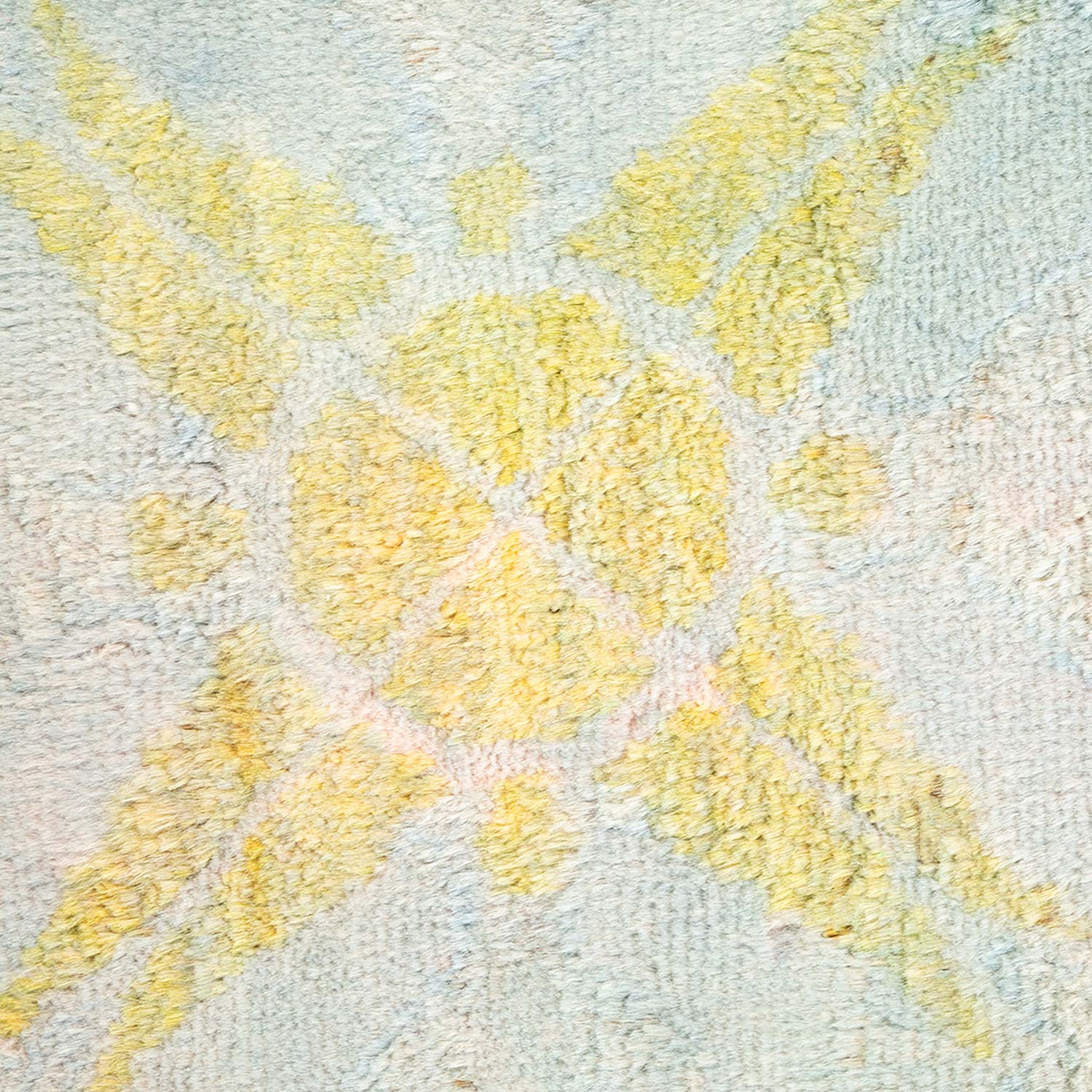 Close-up of a fluffy yellow textured carpet with symmetrical pattern