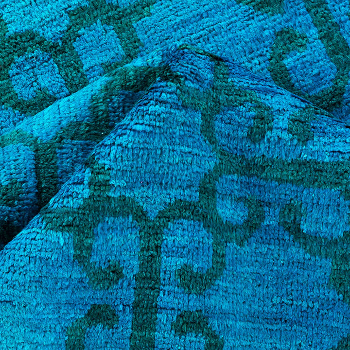 Abstract blue textured surface with irregular bumps and shades.