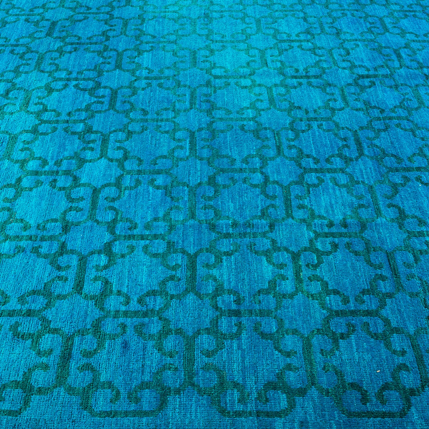 Close-up of a vibrant blue carpet with an intricate design.