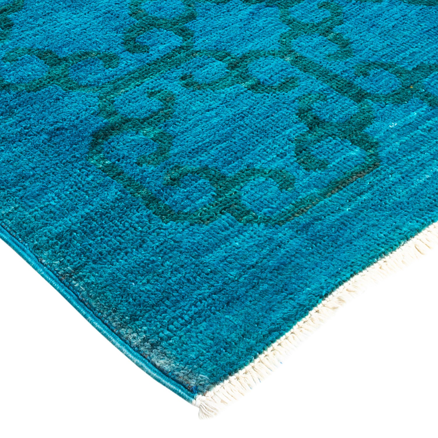 Plush blue rug with textured geometric pattern and fringe detail.