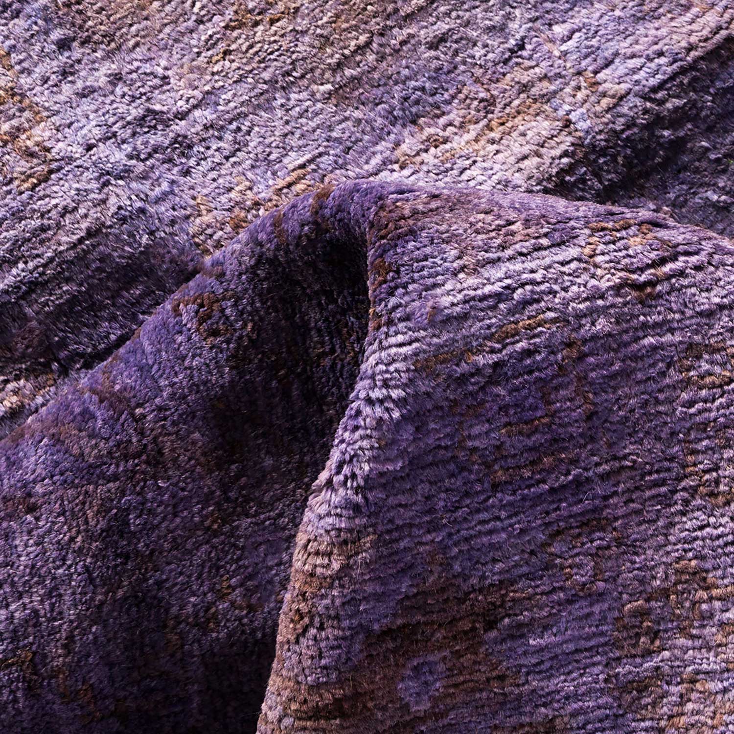 Close-up of soft, plush fabric in varying shades of purple.