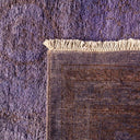 Close-up of a textile rug with contrasting textures and colors.