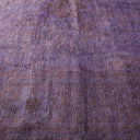 Vintage purple fabric with faded patterns exuding a worn charm.
