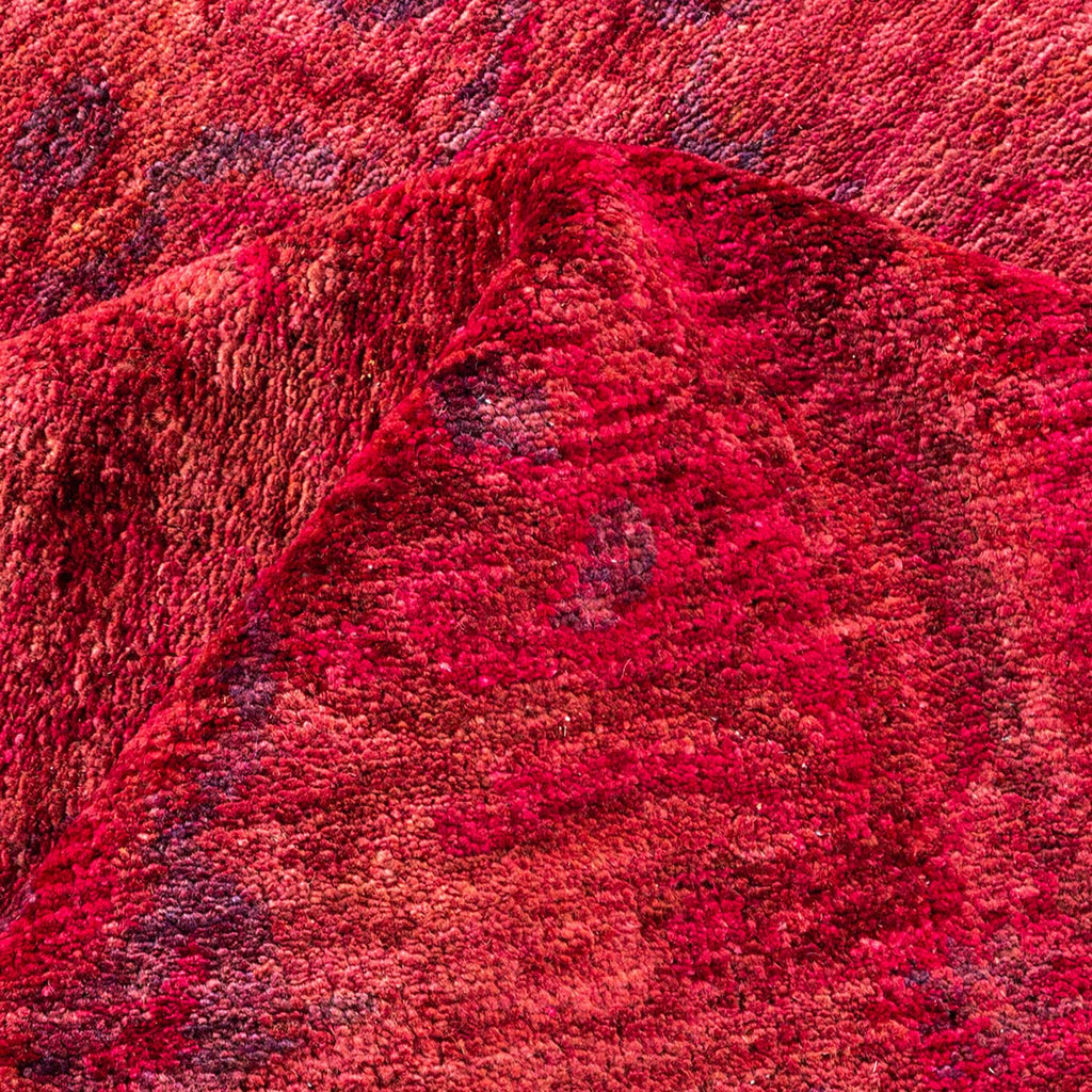 Close-up of a soft, plush, variegated red fabric with texture.