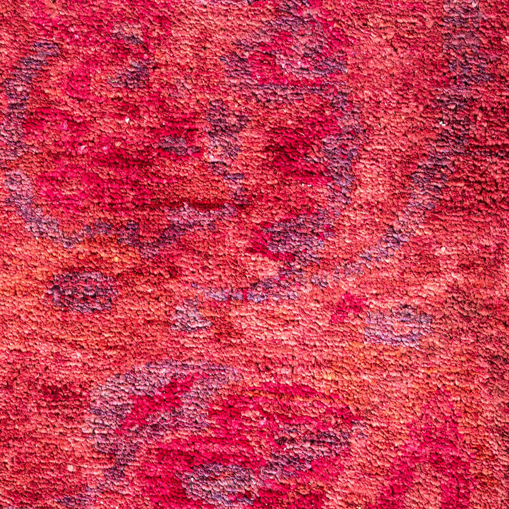 Close-up of a rich, mottled red fabric with textured variations.
