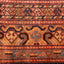 Intricate, symmetrical textile with geometric motifs in red and blue.
