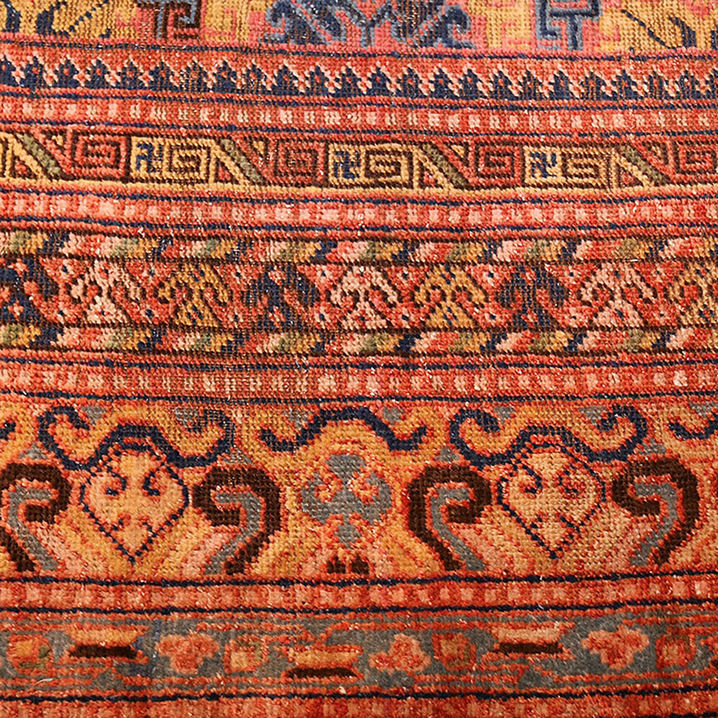 Vibrant, symmetrical handcrafted rug showcases intricate patterns from cultural traditions.