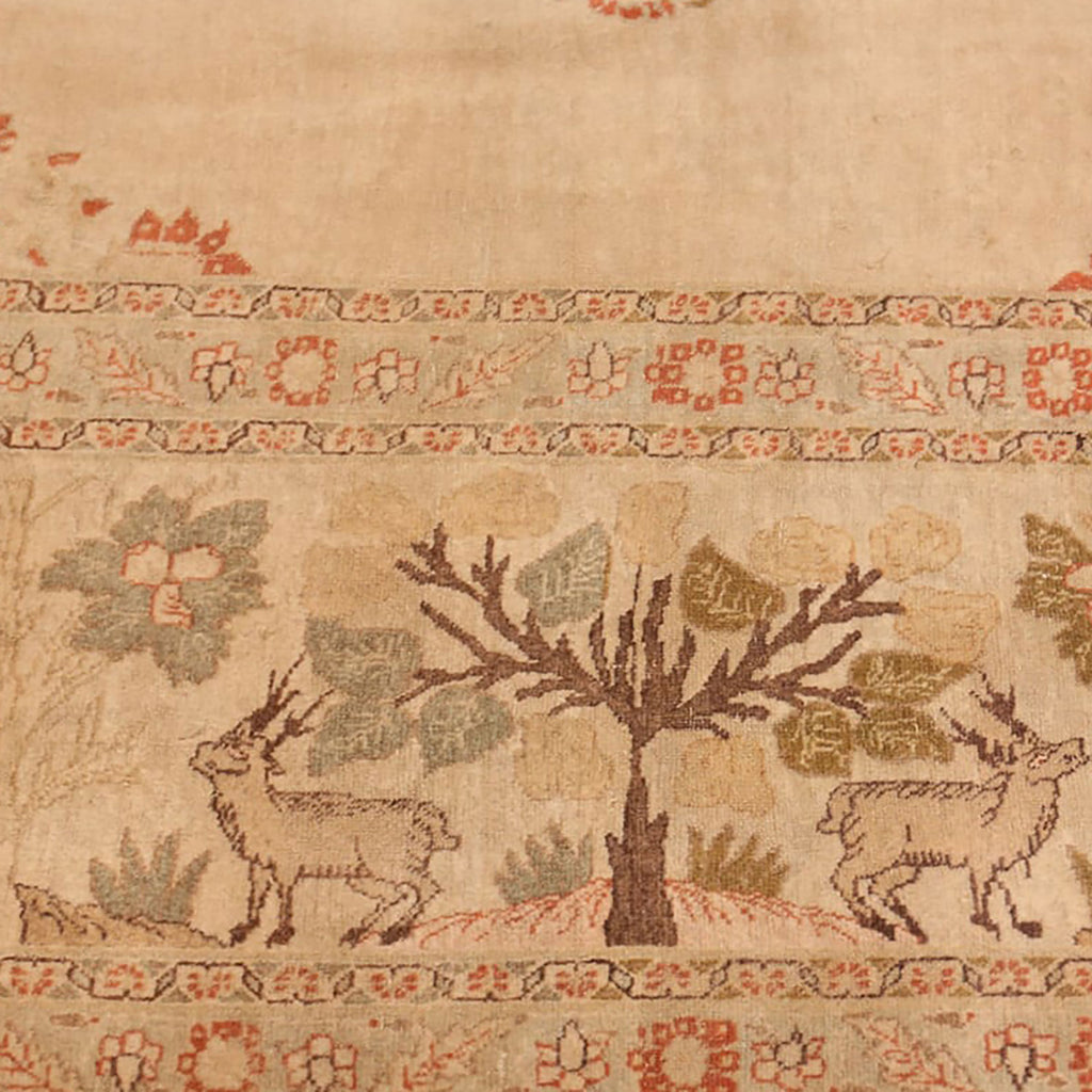 Intricate traditional textile featuring a central tree and deer motifs.