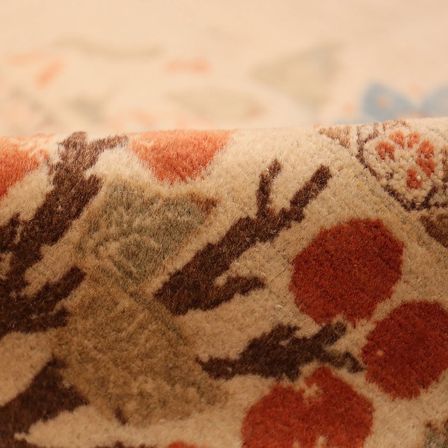 Close-up of an intricately patterned fabric with floral motifs.