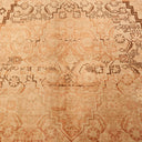 Intricately designed antique rug with symmetrical floral and geometric patterns.