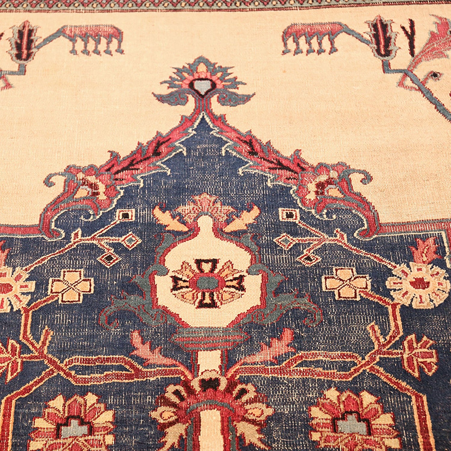 Intricately designed traditional rug with symmetrical floral and geometric motifs.