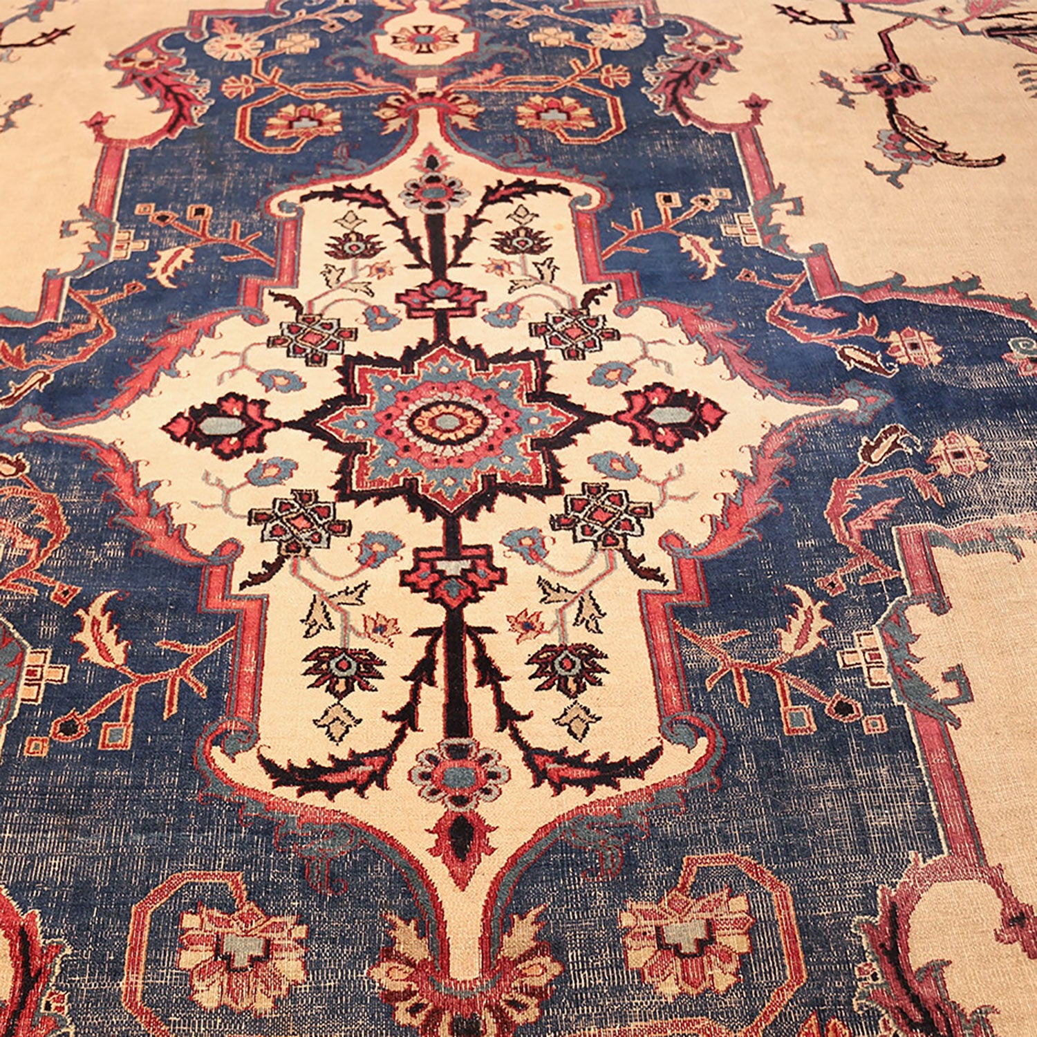 Close-up of an ornate, detailed Persian-inspired carpet with intricate design.