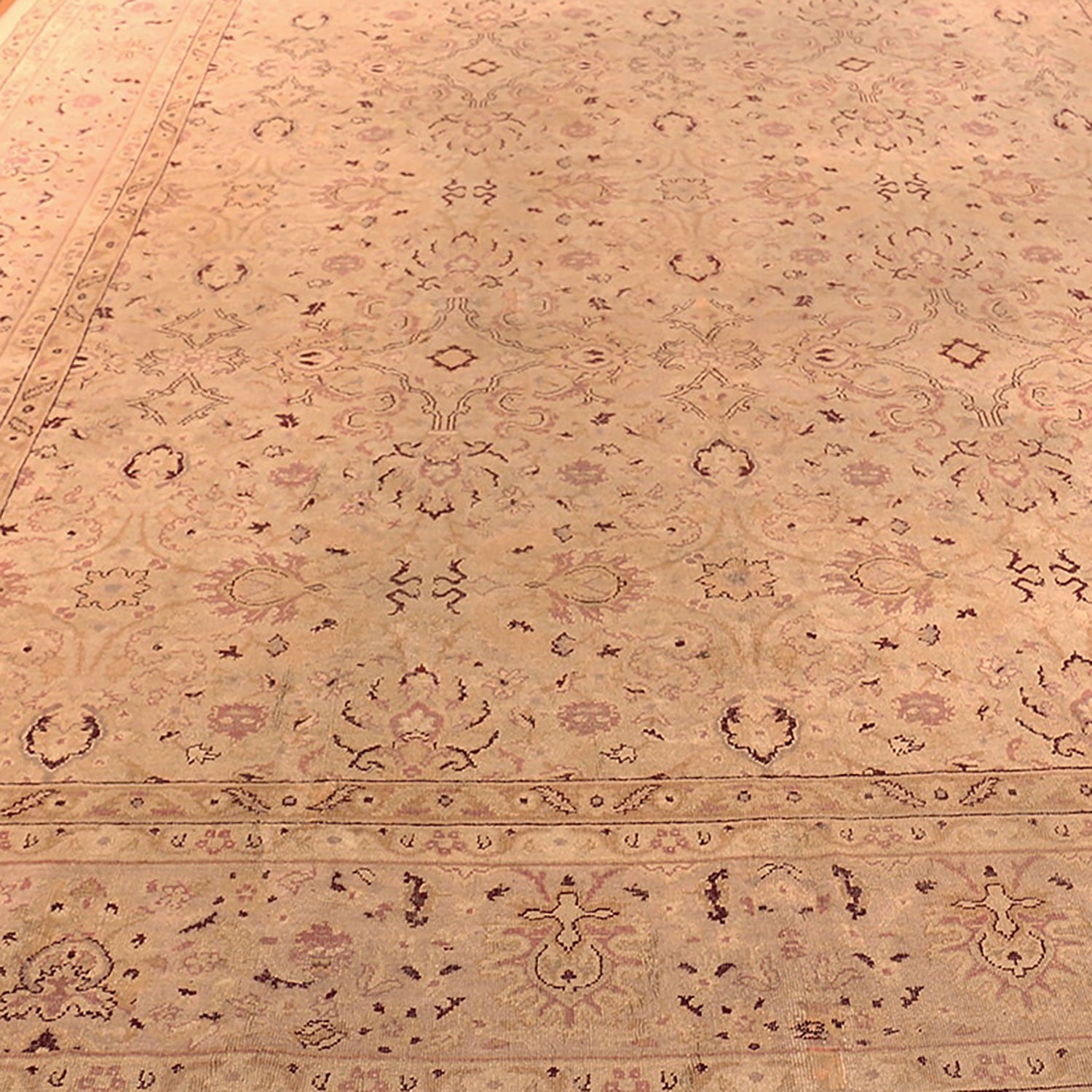 Intricate Middle Eastern-inspired carpet with warm, subdued color palette.
