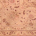 Close-up of a vintage Oriental rug with floral motifs and warm tones.