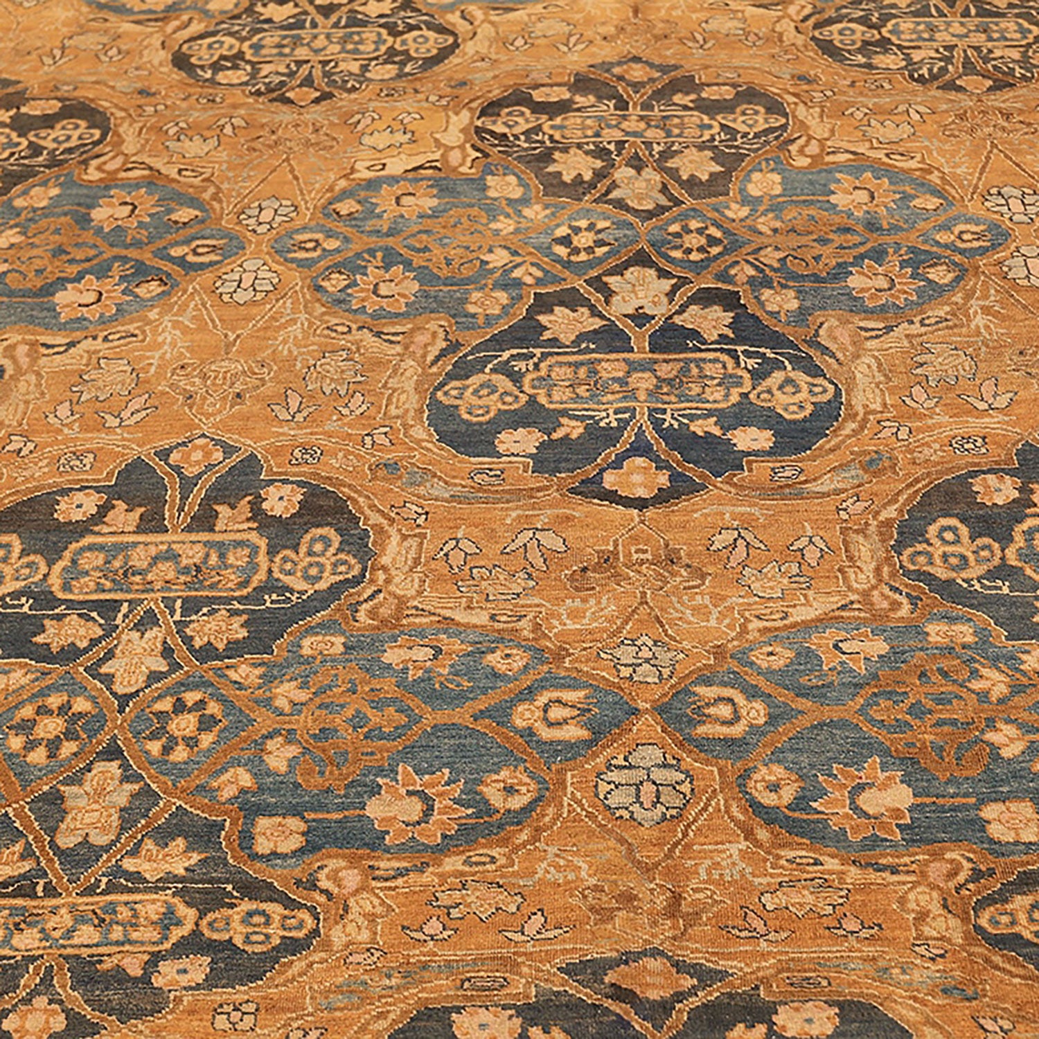 Close-up of a richly patterned carpet with floral and geometric motifs.